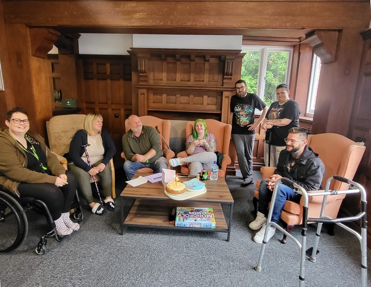 Residents and staff together in the lounge at one of our properties